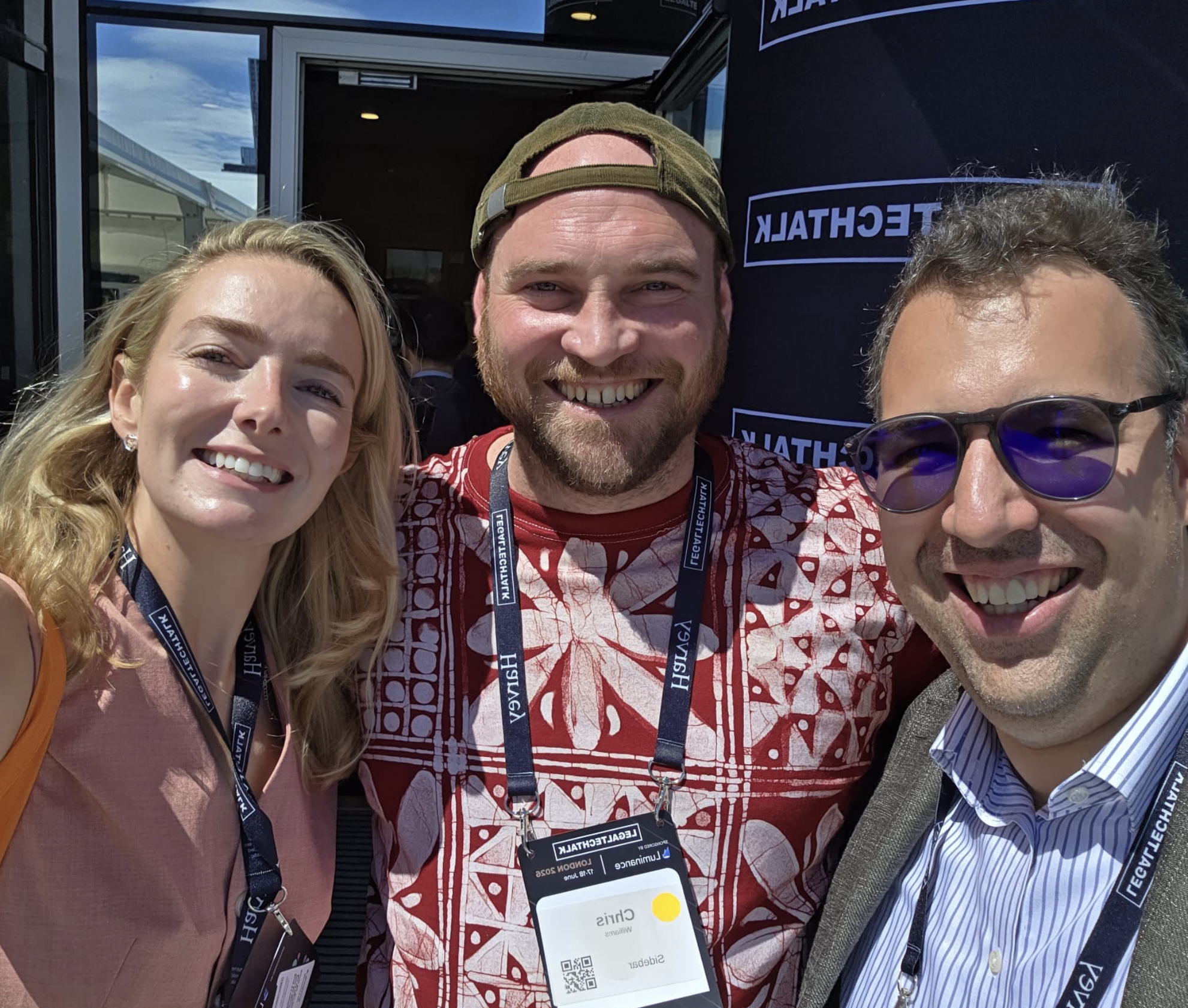 SJ with Chris Williams and a friend at the LegalTechTalk 2026 backdrop